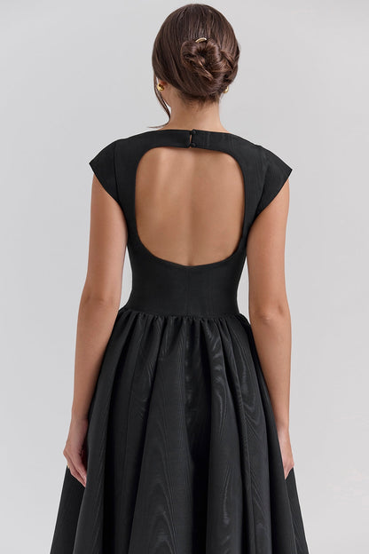 Close-up back of black midi dress showing scoop back cutout and button closure at neckline
