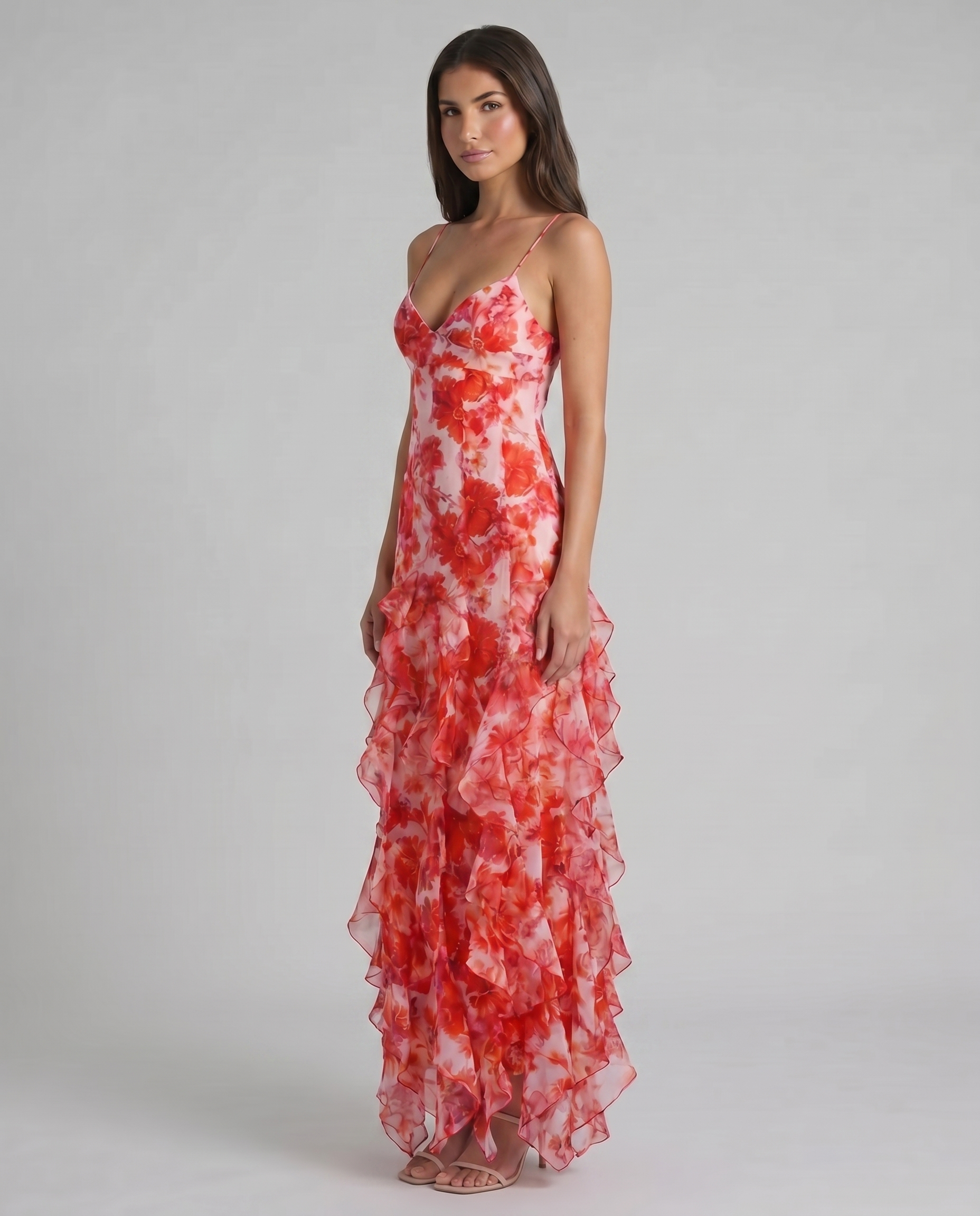 Three-quarter view of red floral maxi dress with fitted waist and layered ruffle skirt