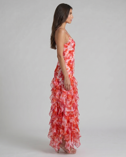 Side profile of red floral maxi dress showing slim silhouette, spaghetti straps, and ruffle hem