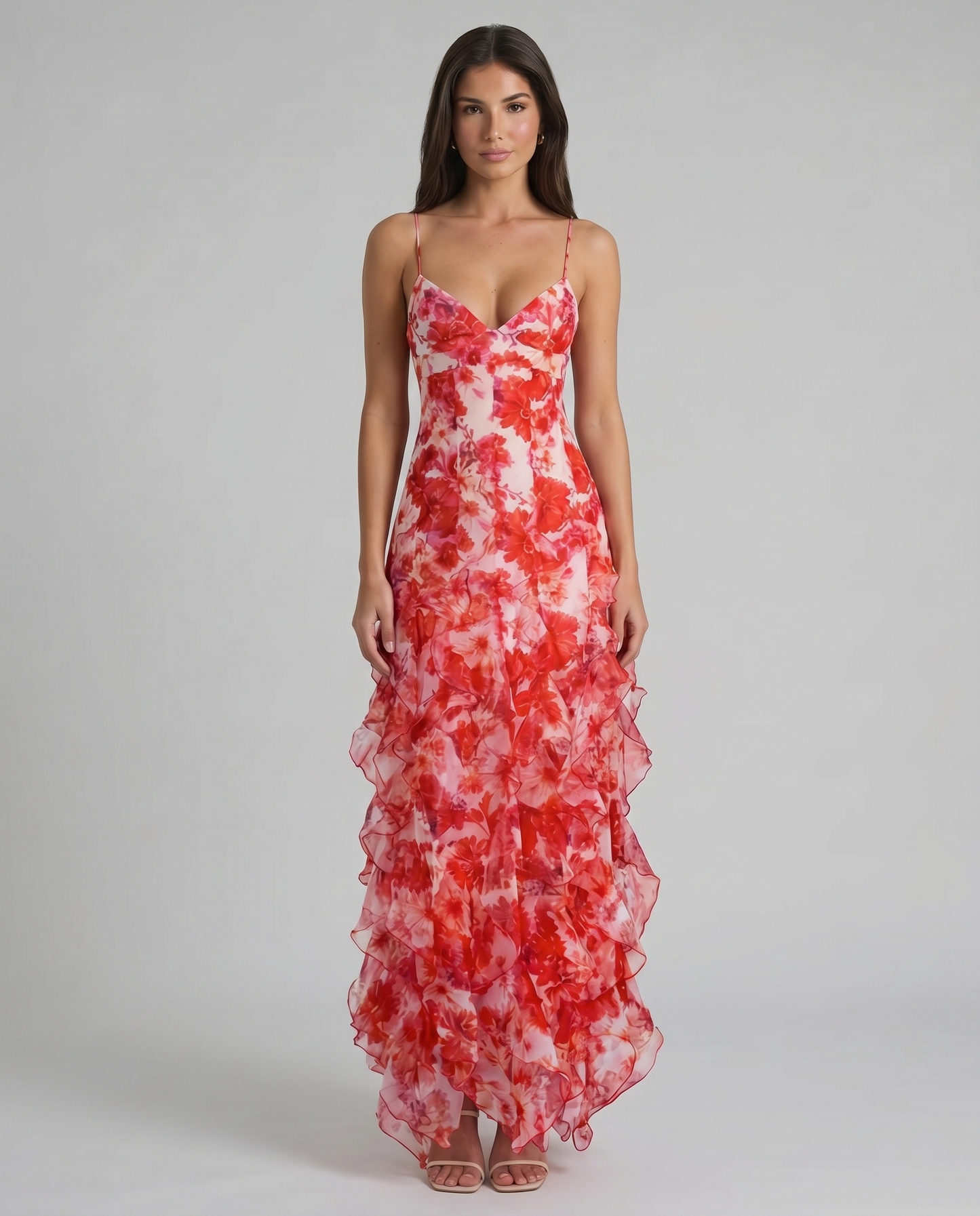 Front view of red floral maxi dress with spaghetti straps, v-neck bodice, and ruffle hem