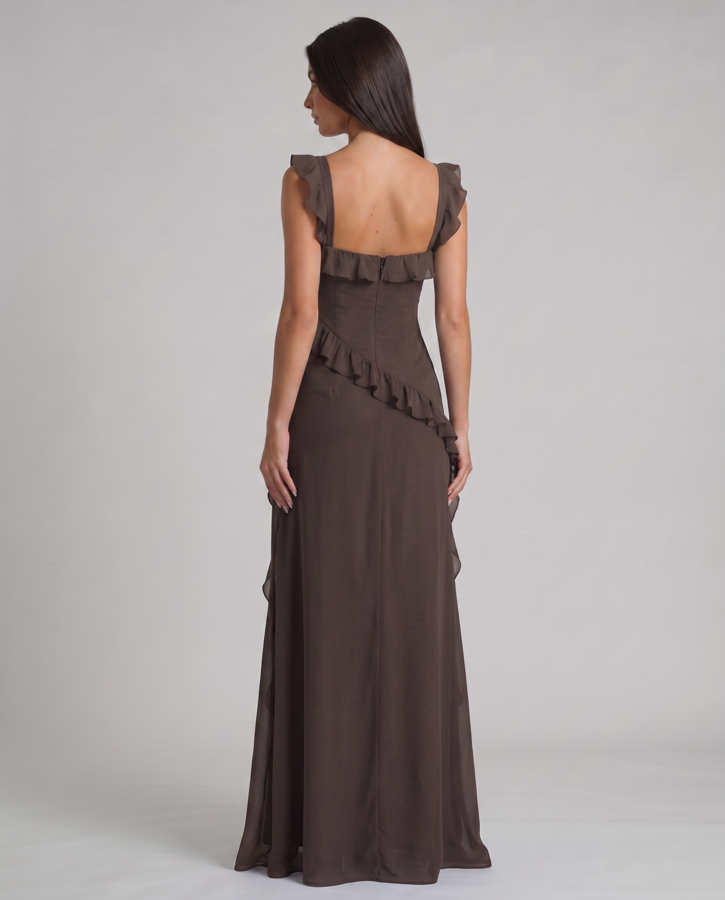 Back view of black maxi dress with square back neckline, center zipper and diagonal ruffle detail
