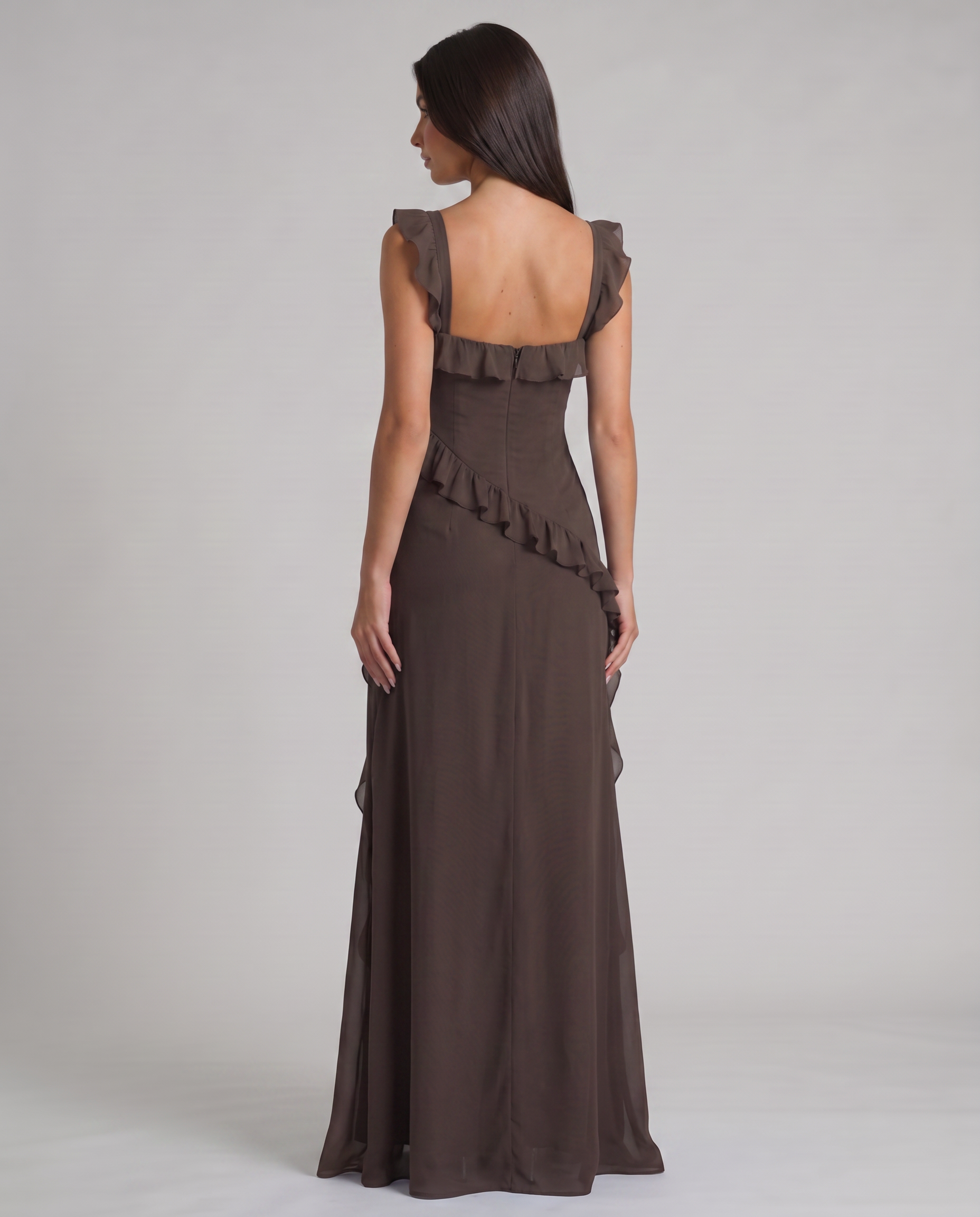 Back view of black maxi dress with square back neckline, center zipper and diagonal ruffle detail