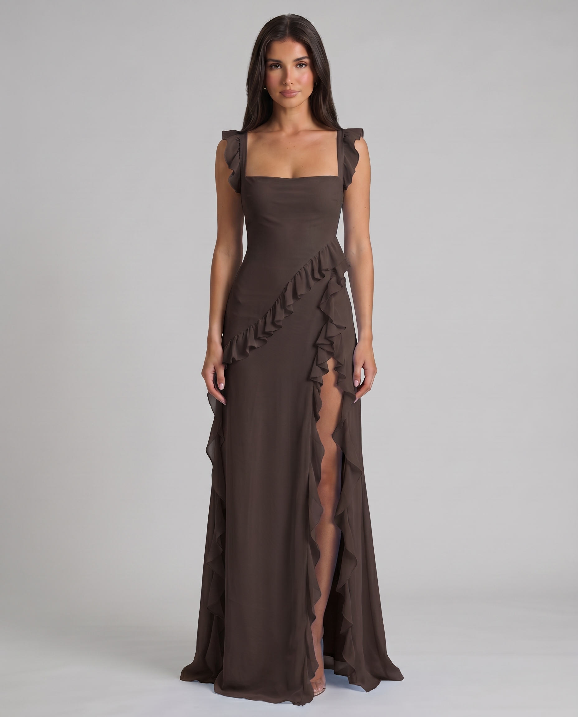 Hem detail of black maxi dress with lightweight sheer overlay and pooled floor-length skirt finish