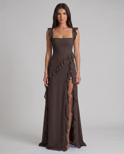 Black maxi dress with square neckline, ruffled straps, diagonal ruffle trim and high slit, front view