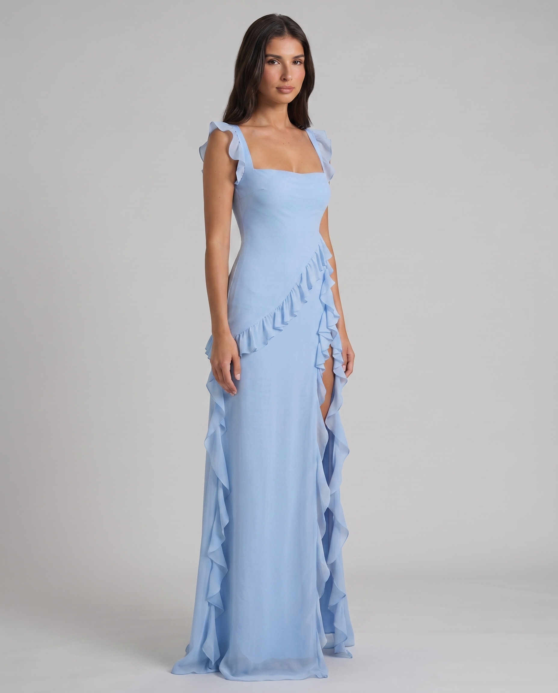 Angled front view of light blue maxi dress with square neck bodice, flutter sleeves and ruffle skirt