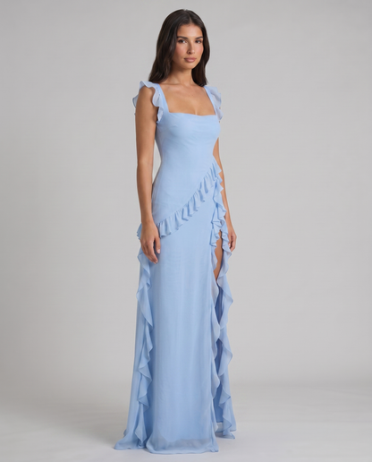 Three-quarter view of light blue maxi dress with flutter straps, cascading ruffle trim and slit