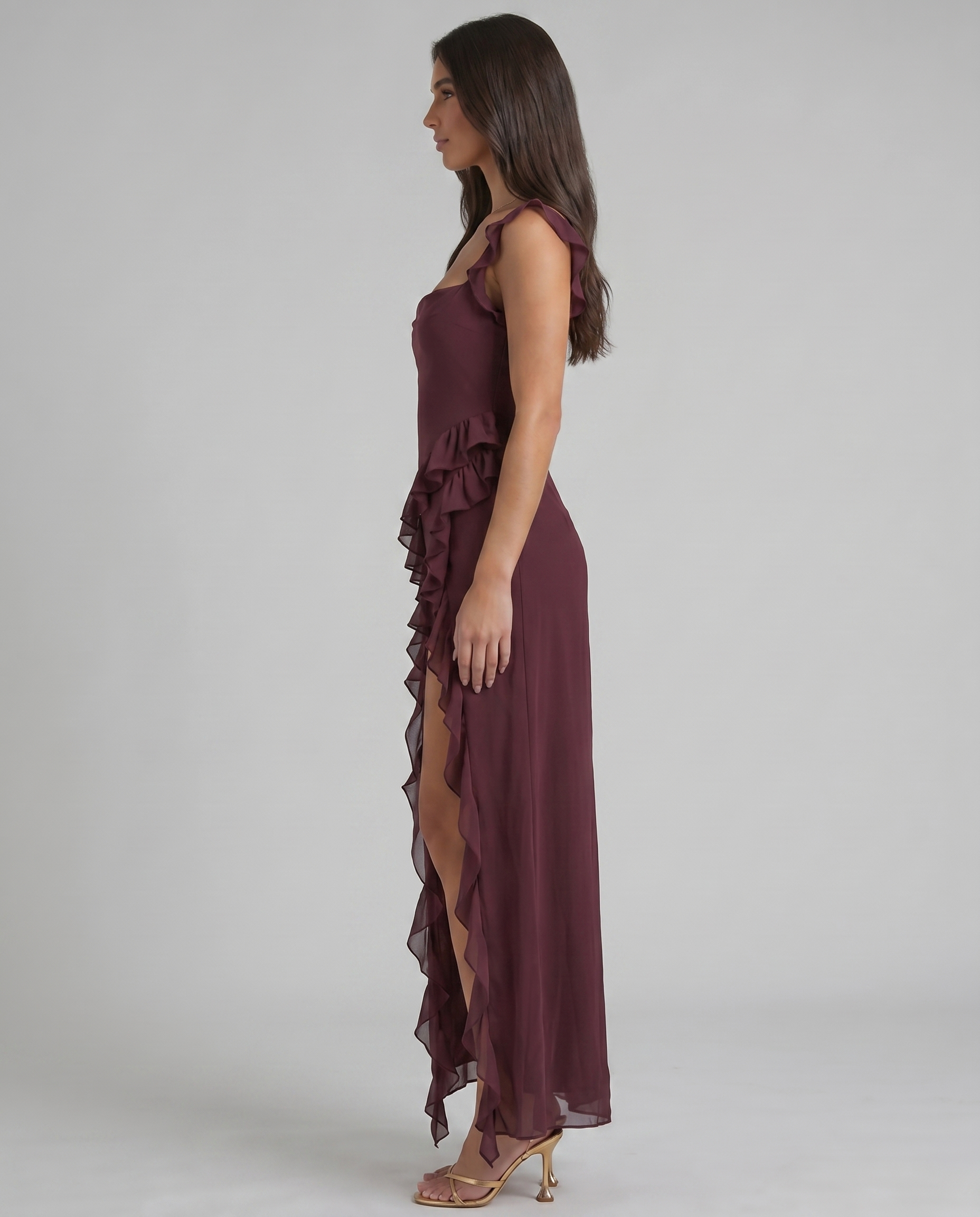 Side profile of purple maxi dress featuring layered ruffle side detail and soft chiffon drape