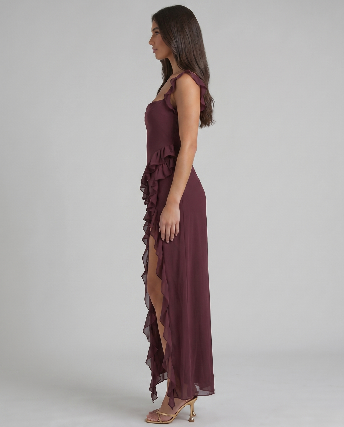 Back detail of purple maxi dress with ruffled scoop neckline and diagonal ruffle down skirt