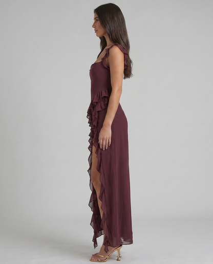 Back detail of purple maxi dress with ruffled scoop neckline and diagonal ruffle down skirt