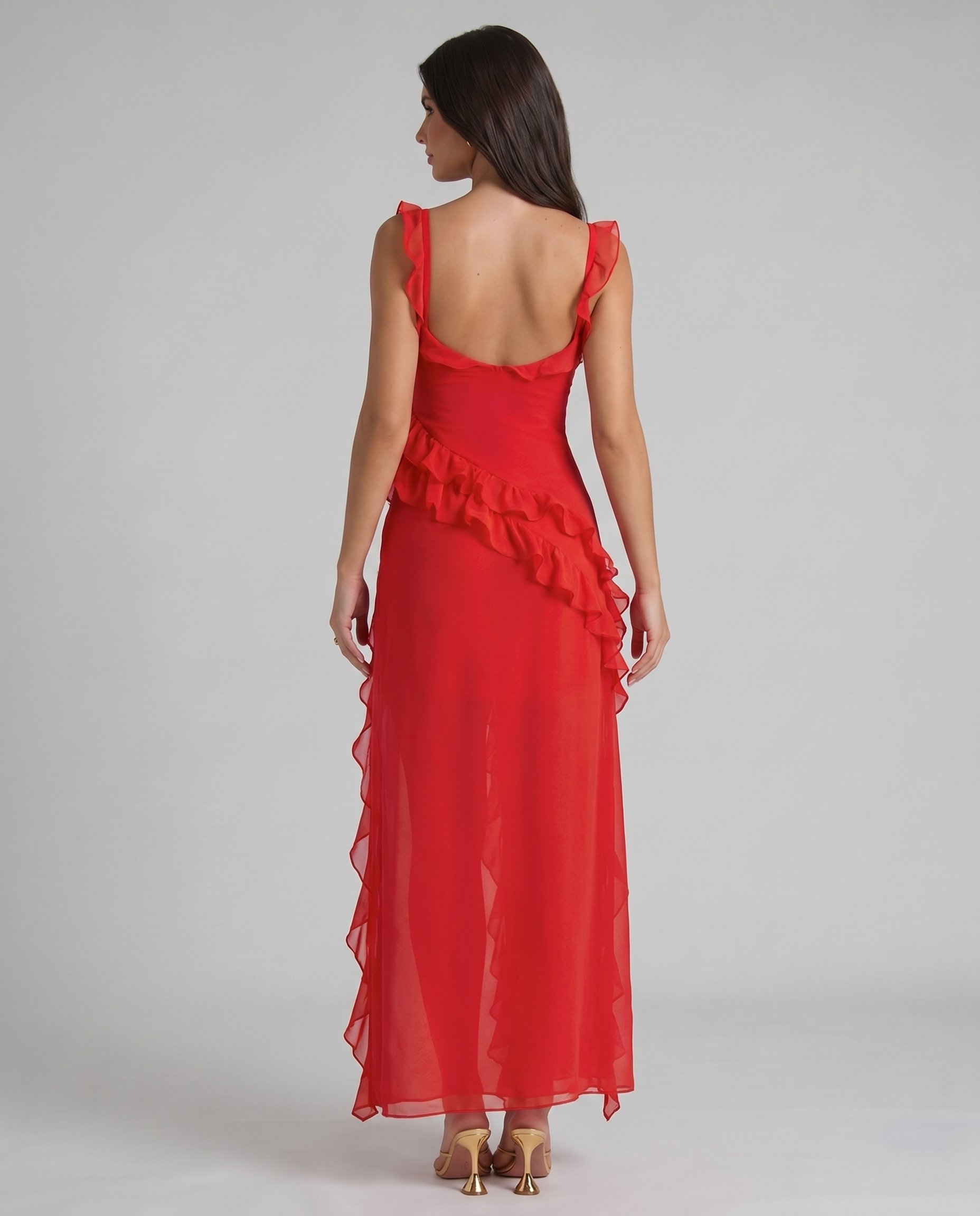Back angle red maxi dress highlighting diagonal ruffle waist detail and lightweight flowy skirt