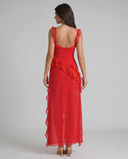 Back angle red maxi dress highlighting diagonal ruffle waist detail and lightweight flowy skirt