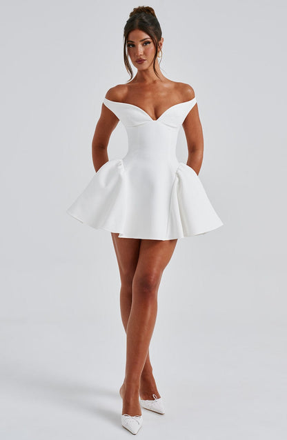 Full front view of white fit-and-flare mini dress with off-shoulder neckline and sculpted waist