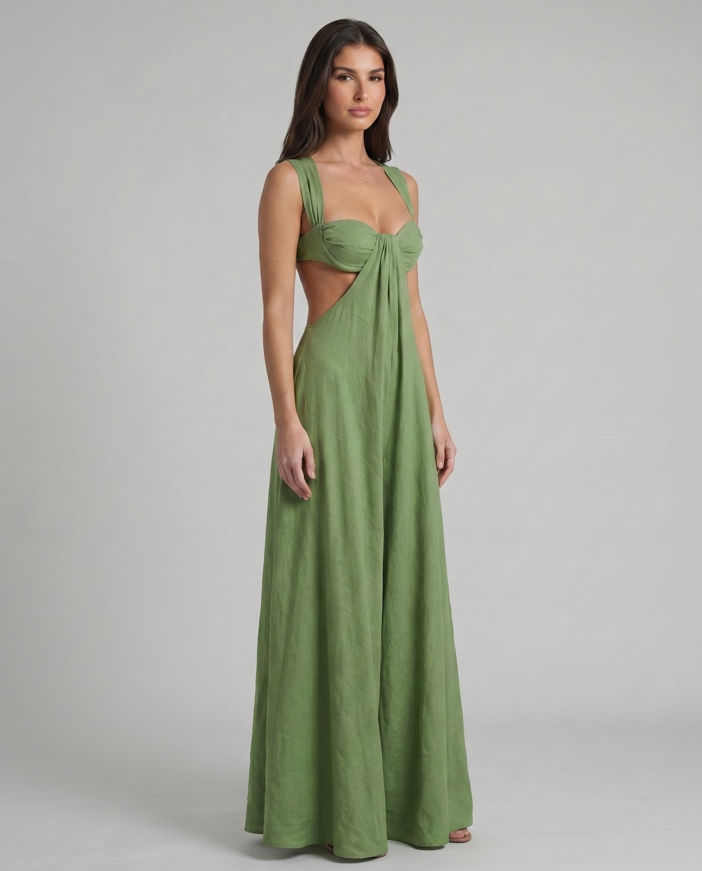 Three-quarter view of green maxi dress with side cutout waist and flowing full-length skirt
