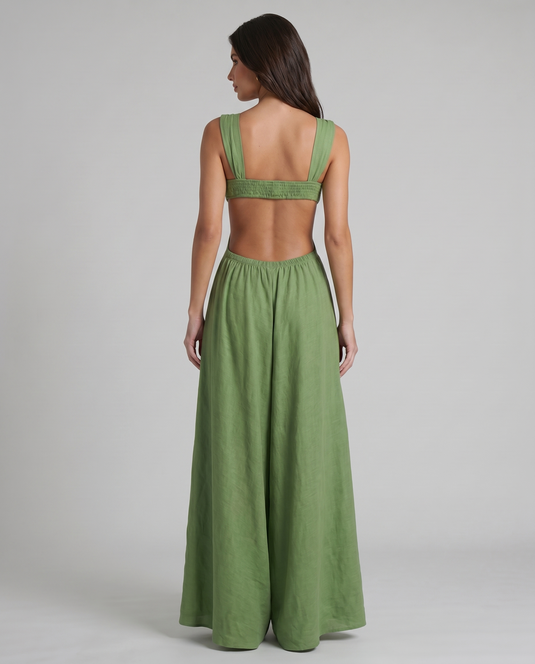 Back view of green maxi dress with open back, wide shoulder straps, and gathered waistband