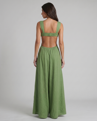 Back view of green maxi dress with open back, wide shoulder straps, and gathered waistband