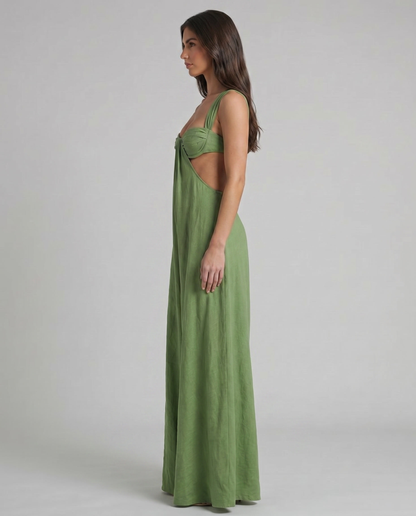 Side profile of green maxi dress showing cutout waist, bustier top, and long draped skirt