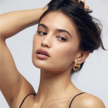 Women gold chunky knot earrings in polished metal