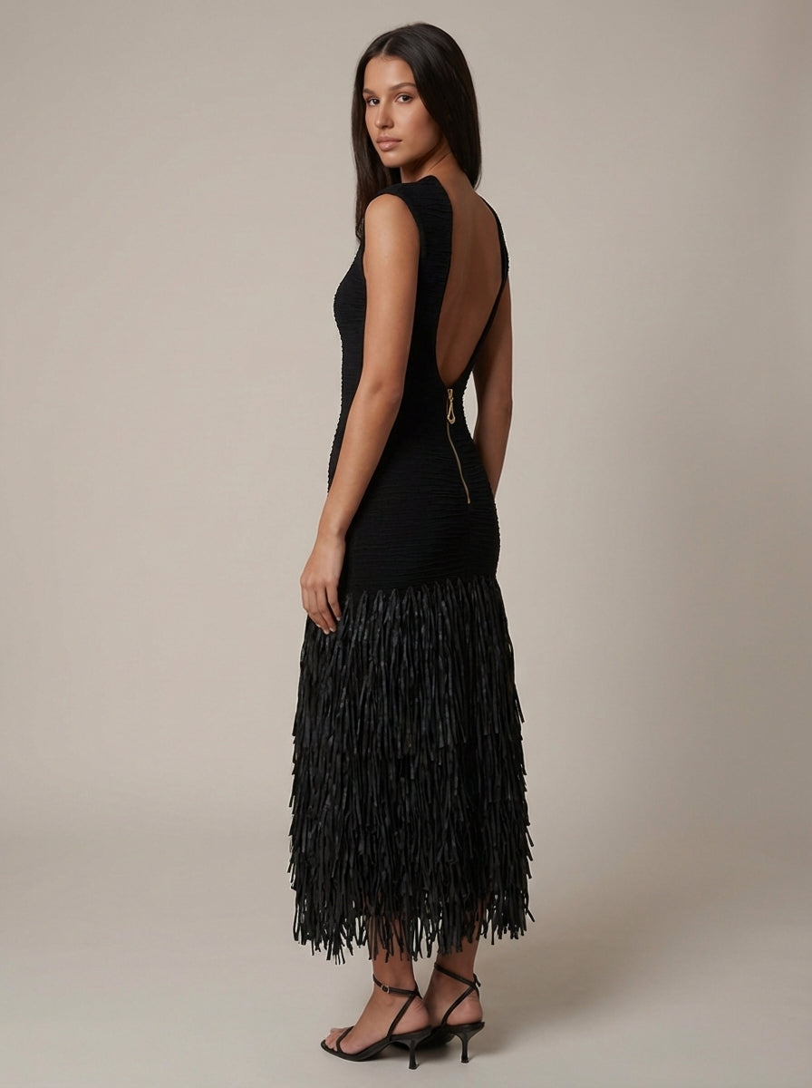 Back angled view of black midi fringe dress with deep open back and exposed zipper detail