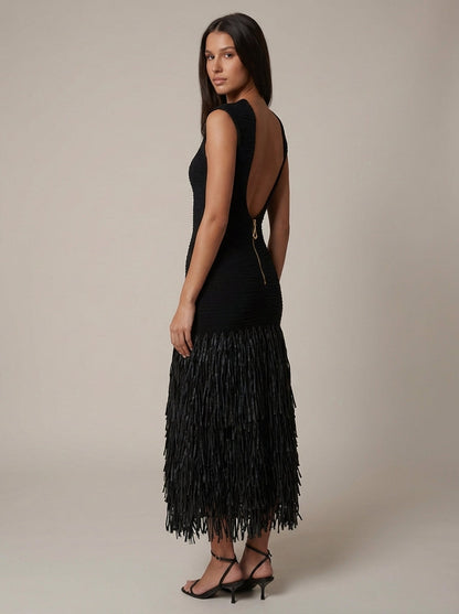 Back angled view of black midi fringe dress with deep open back and exposed zipper detail