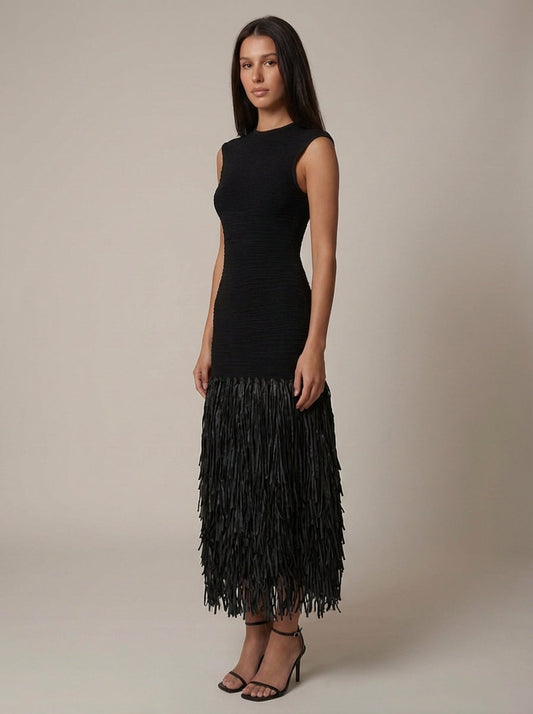 Angled front view of black sleeveless midi fringe dress with textured bodice and tiered tassel skirt
