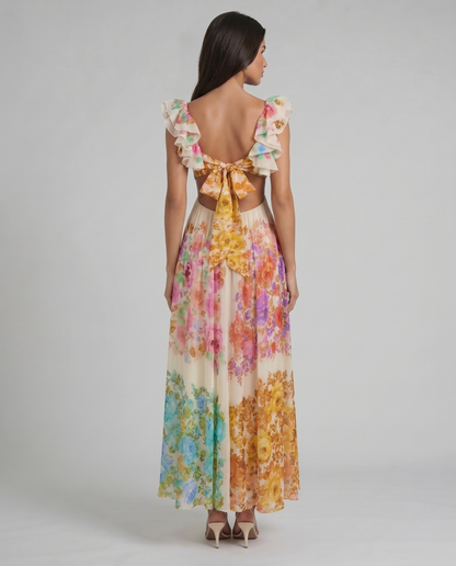 Back view multicolor floral midi dress showing open back and large bow tie with ruffle sleeves