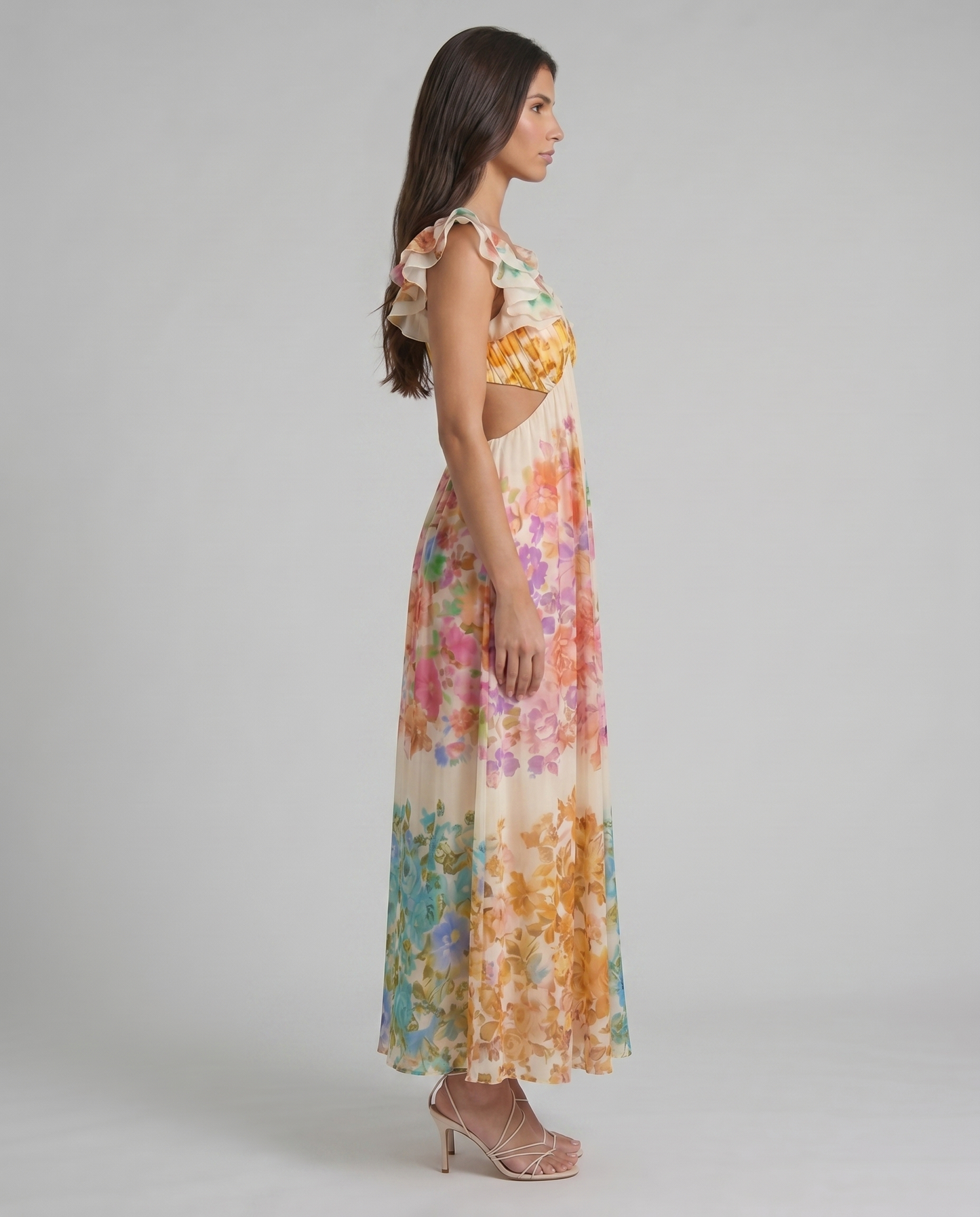 Side profile of multicolor floral midi dress with flowing pleated skirt and ruffle shoulder detail