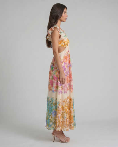 Side profile of multicolor floral midi dress with flowing pleated skirt and ruffle shoulder detail