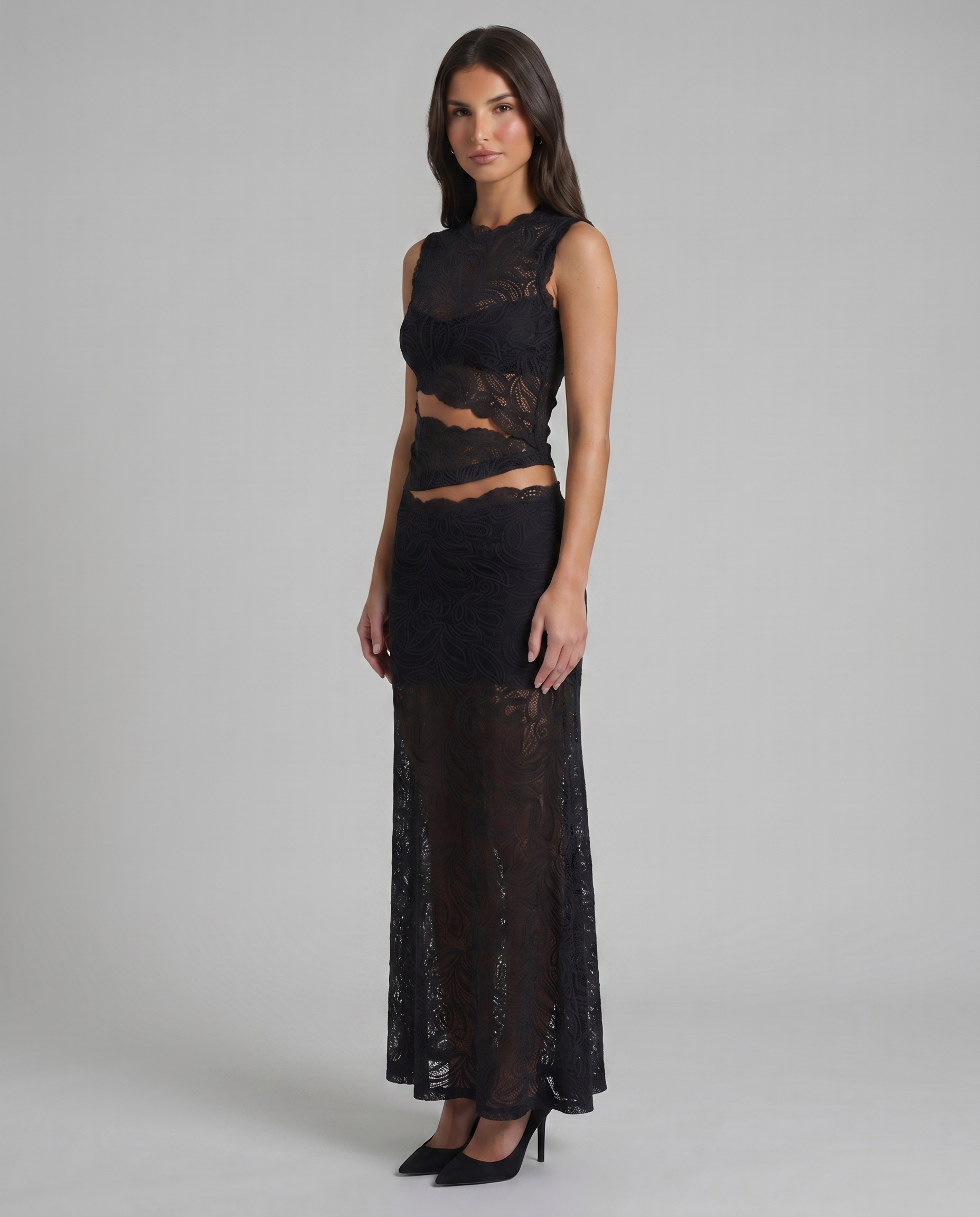 Angled view of black lace crop top and high-waist maxi skirt with scalloped edges