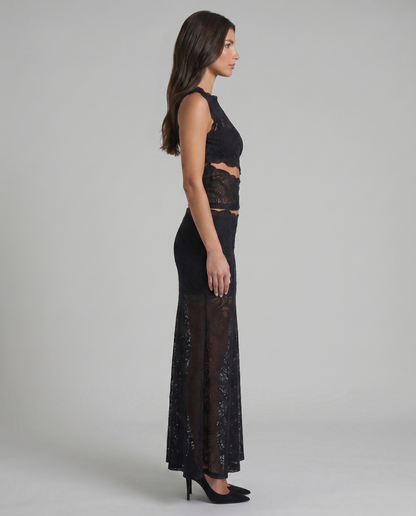 Side profile of black lace two-piece outfit showing fitted top and semi-sheer long skirt