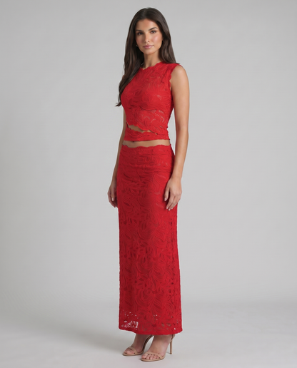 Angle view of red lace crop top and matching maxi skirt set with scalloped hem details