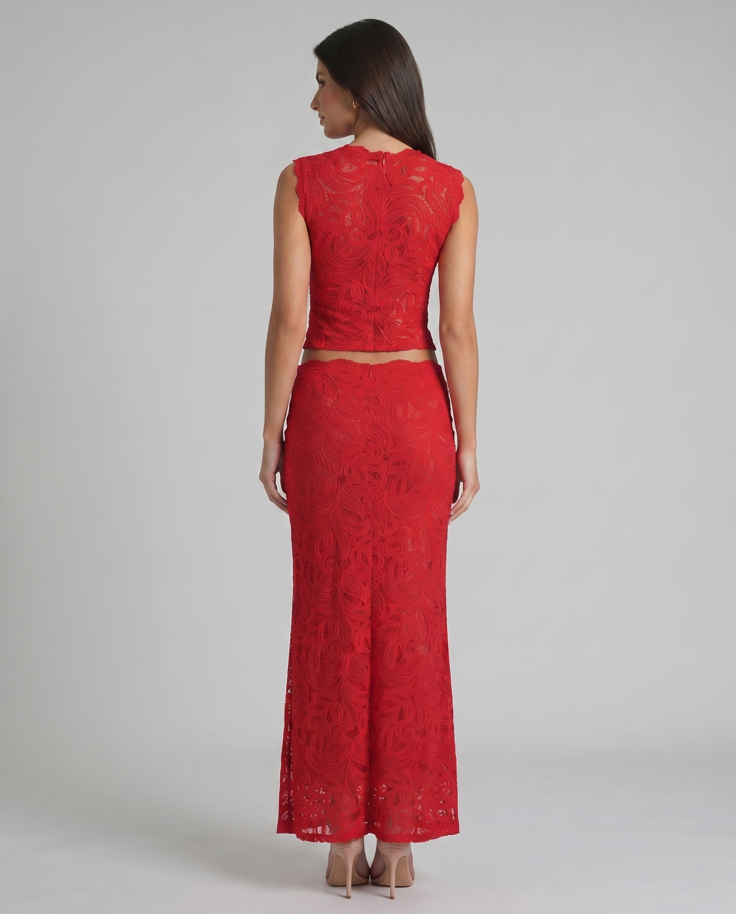 Back view of red lace two-piece set showing sleeveless top closure and fitted maxi skirt