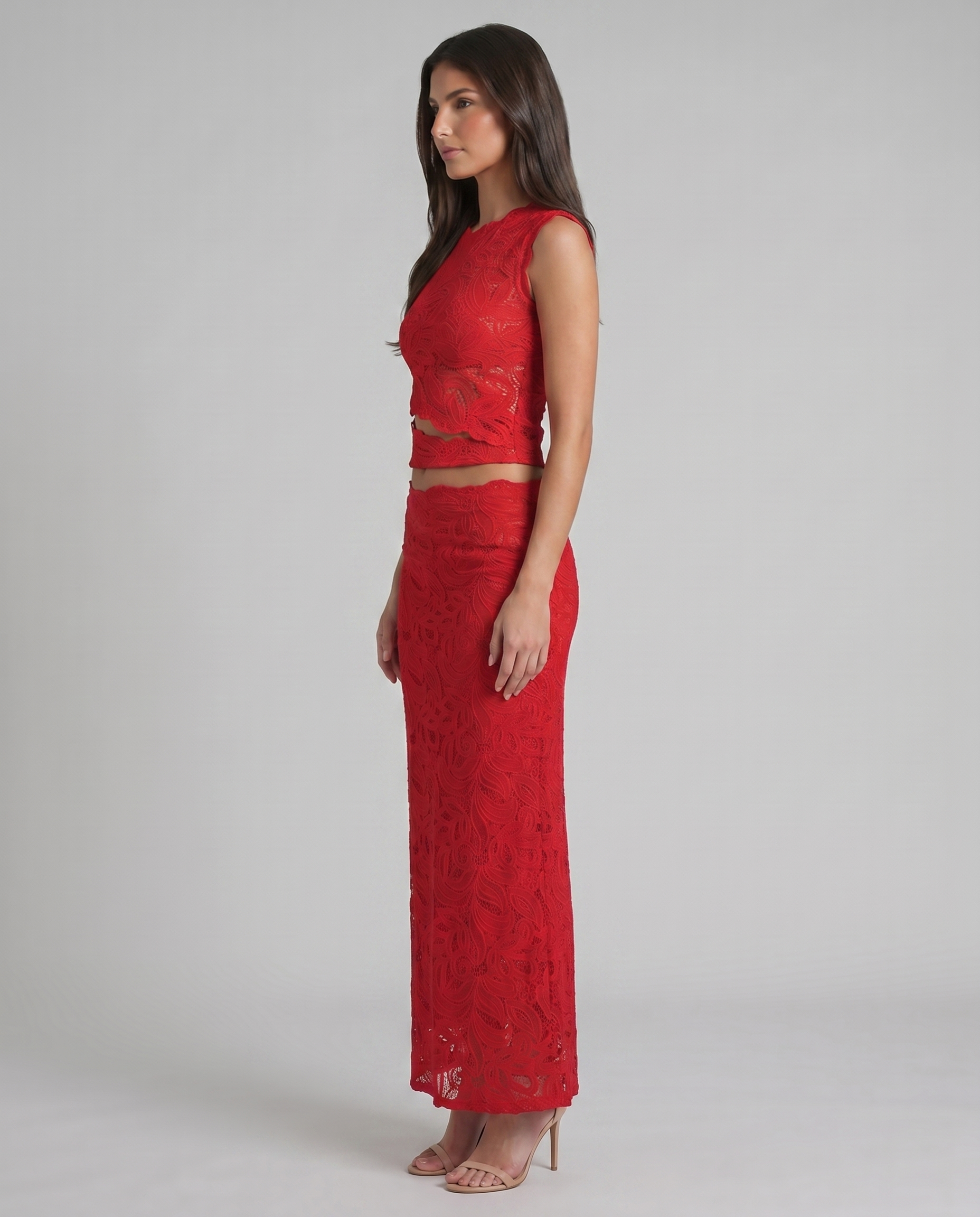 Side profile of red lace skirt set with scalloped crop top hem and long straight skirt