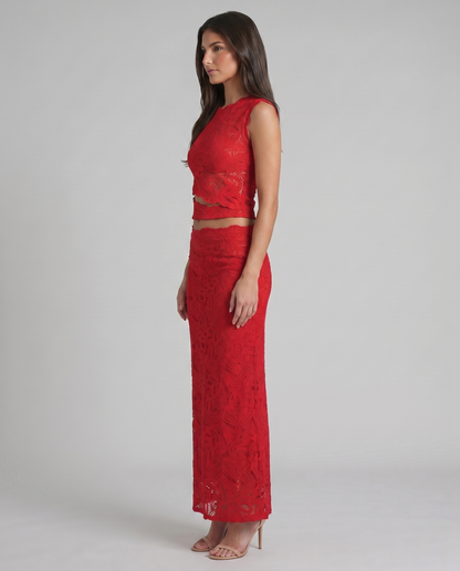 Side profile of red lace skirt set with scalloped crop top hem and long straight skirt