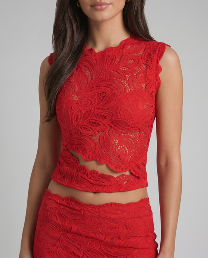Close-up of red lace sleeveless crop top with floral pattern and scalloped waist band