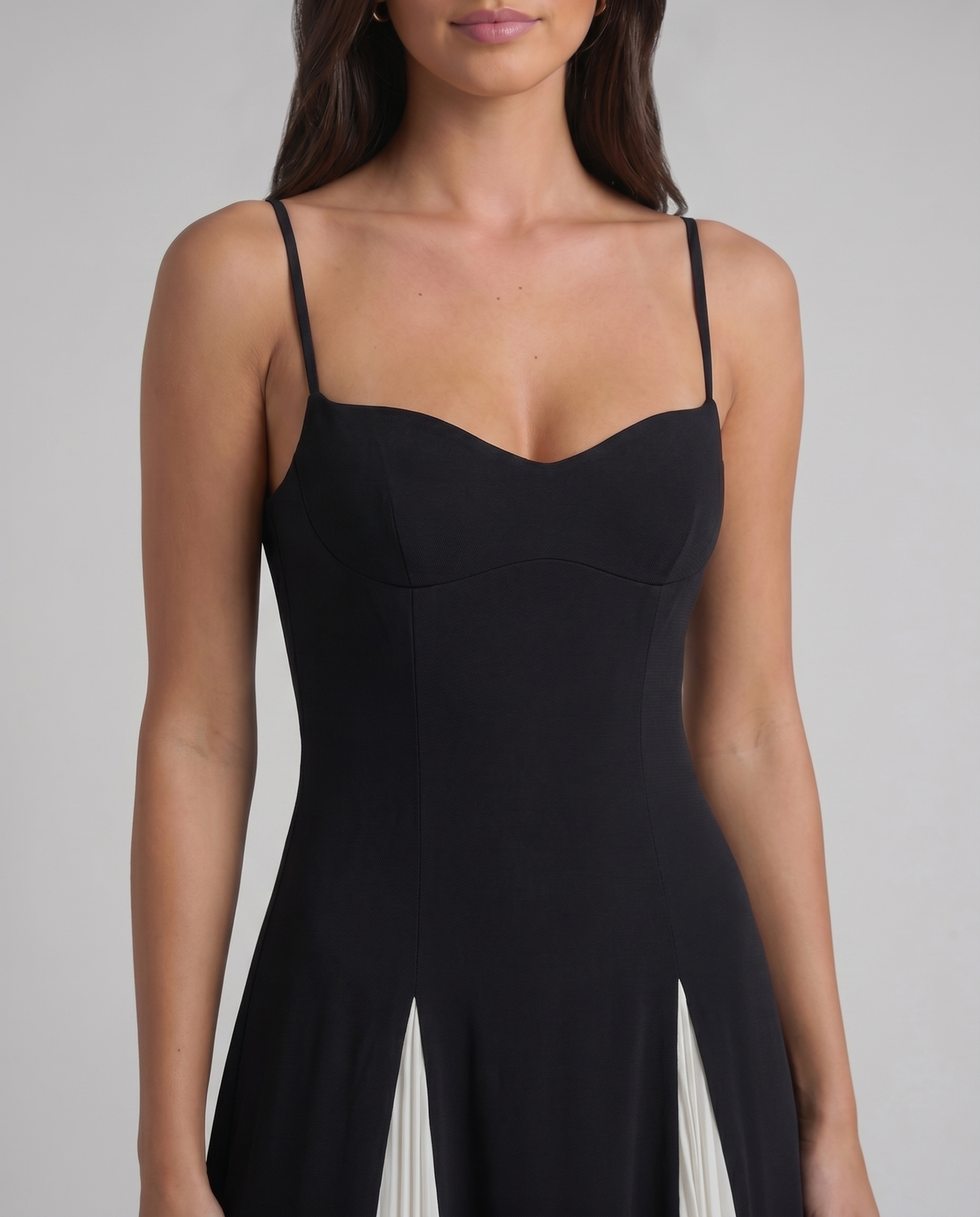 Close-up of sweetheart neckline bodice on white and black romantic maxi dress with spaghetti straps