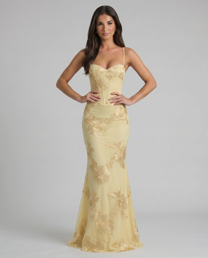 Front view of yellow maxi dress with sweetheart neckline, corset stitching, and floral embroidery