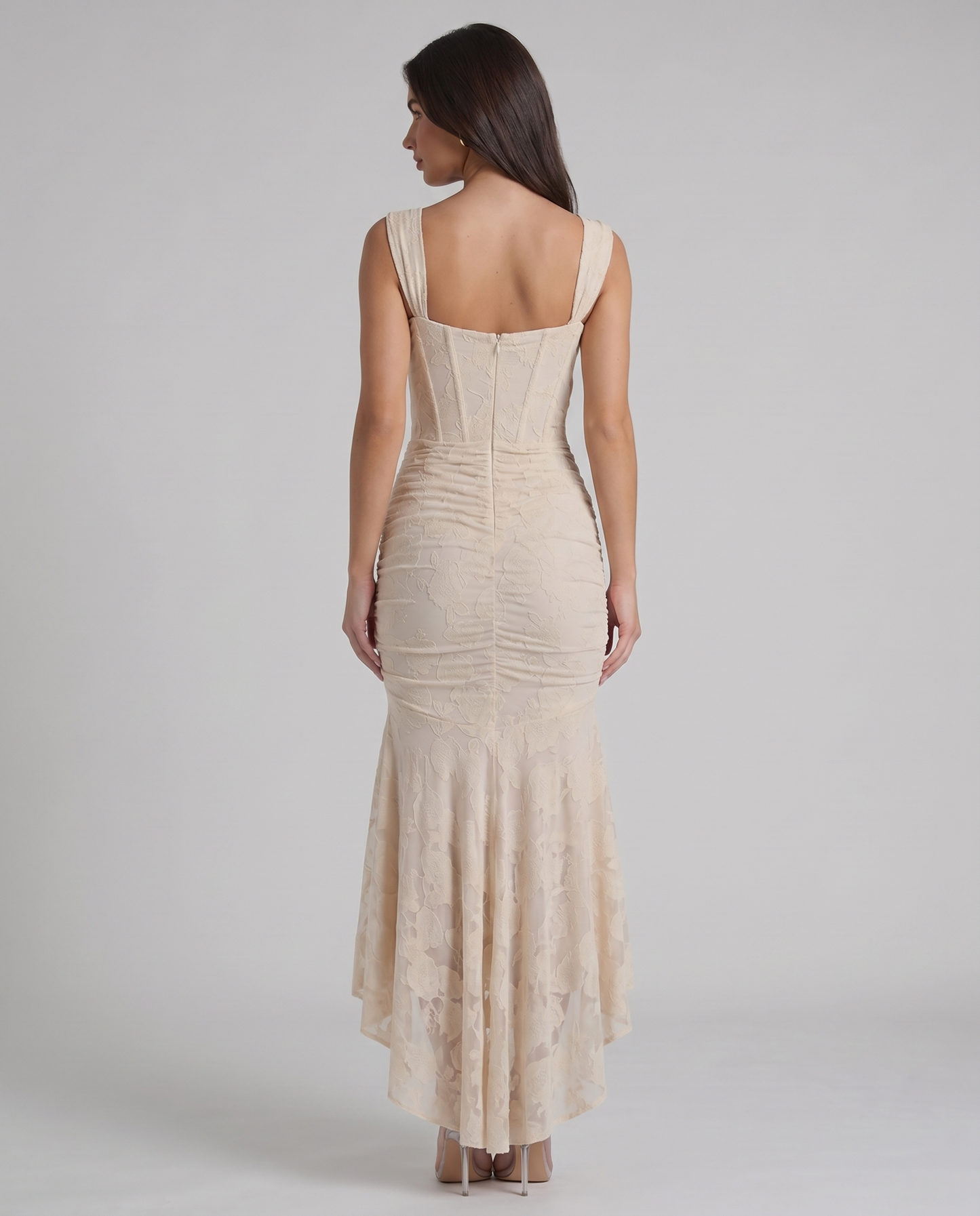 Back view of beige corset maxi dress showing square back neckline, fitted bodice and zip closure