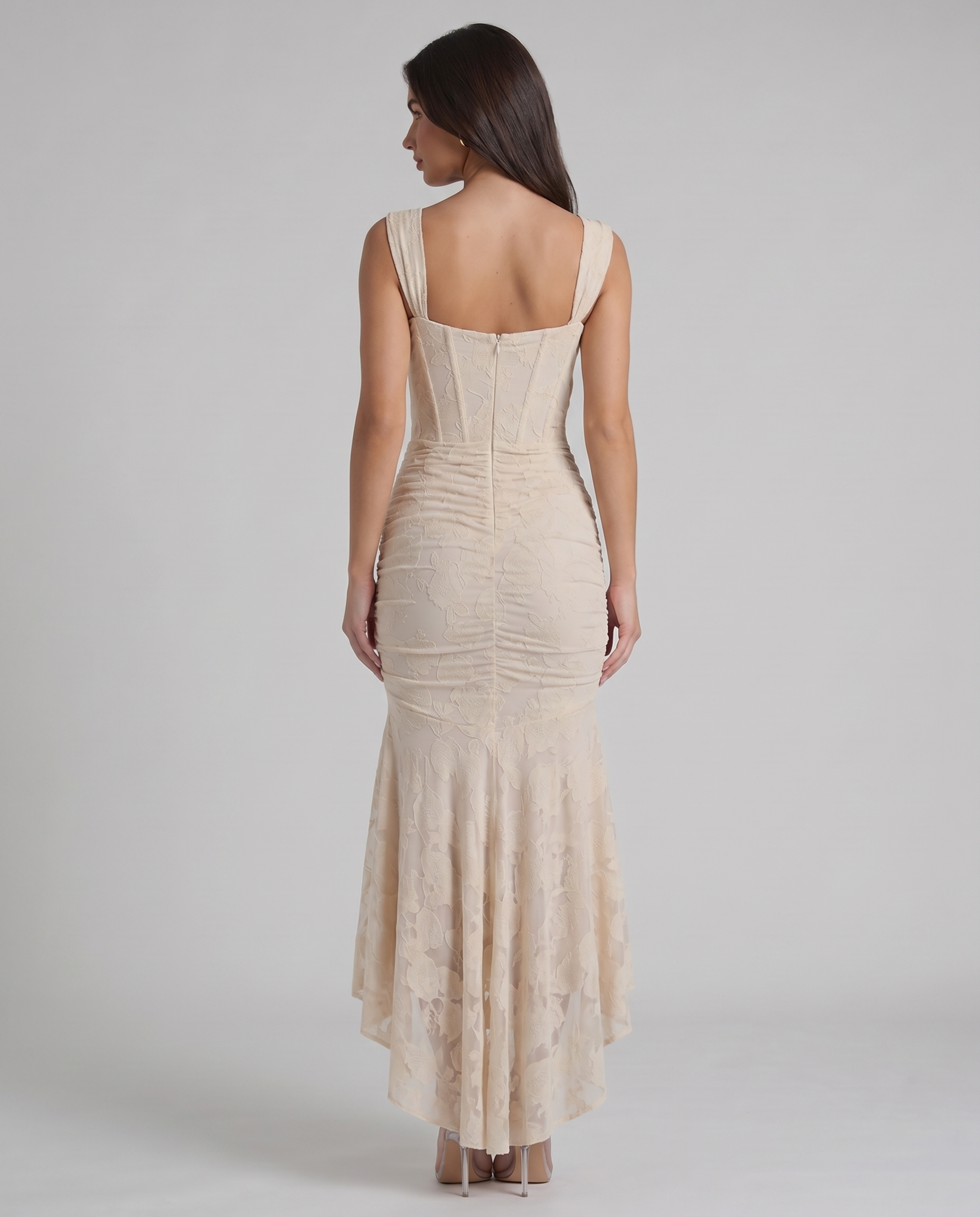 Back view of beige corset maxi dress showing square back neckline, fitted bodice and zip closure