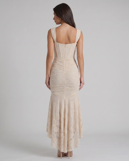 Back view of beige corset maxi dress showing square back neckline, fitted bodice and zip closure