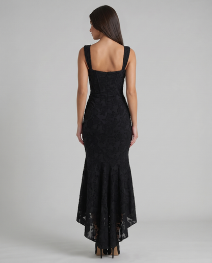Back view of black corset maxi dress with square back neckline, wide straps, center zip and sheer hem