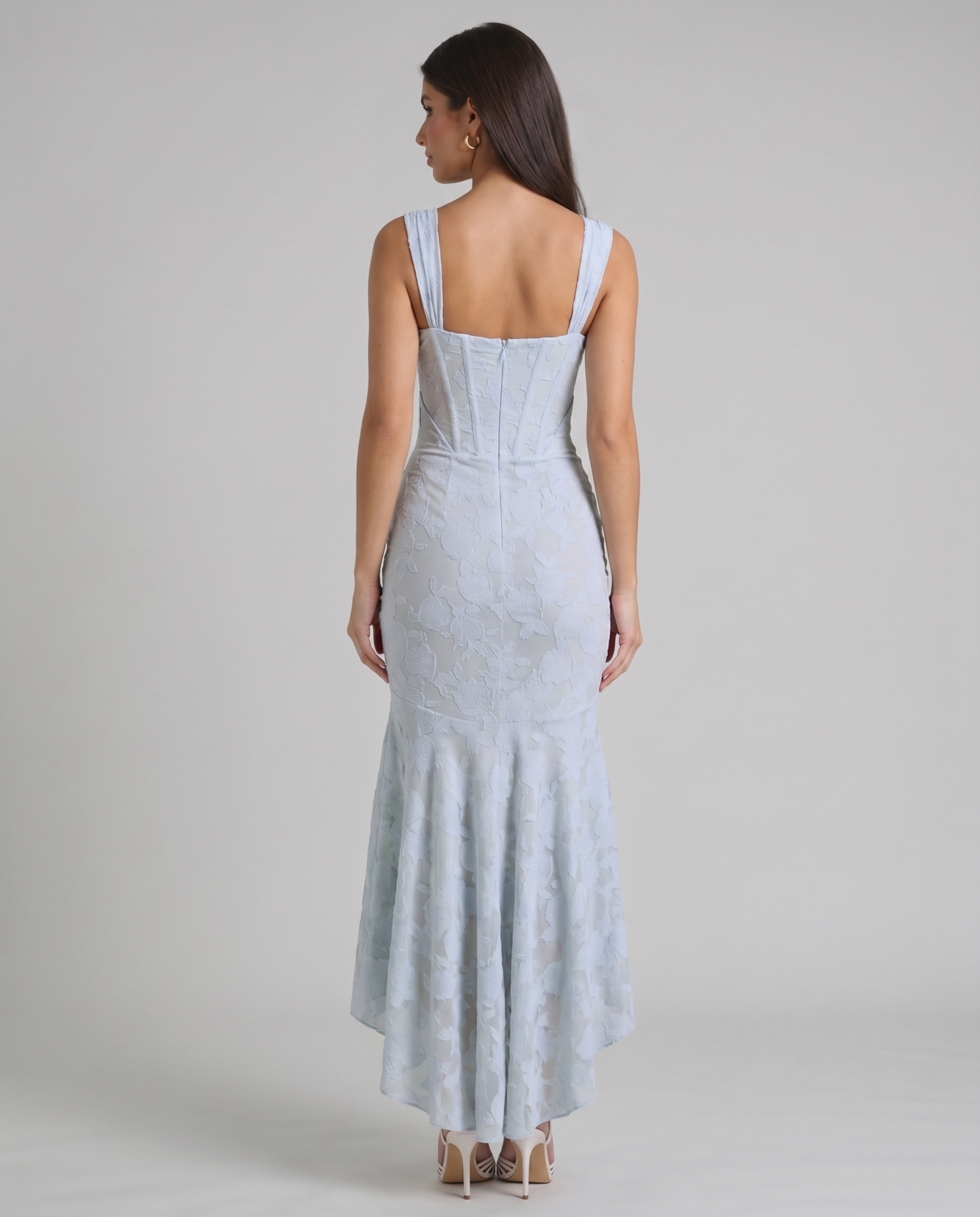 Back view of light blue corset maxi dress showing wide straps, structured seams and back zipper closure