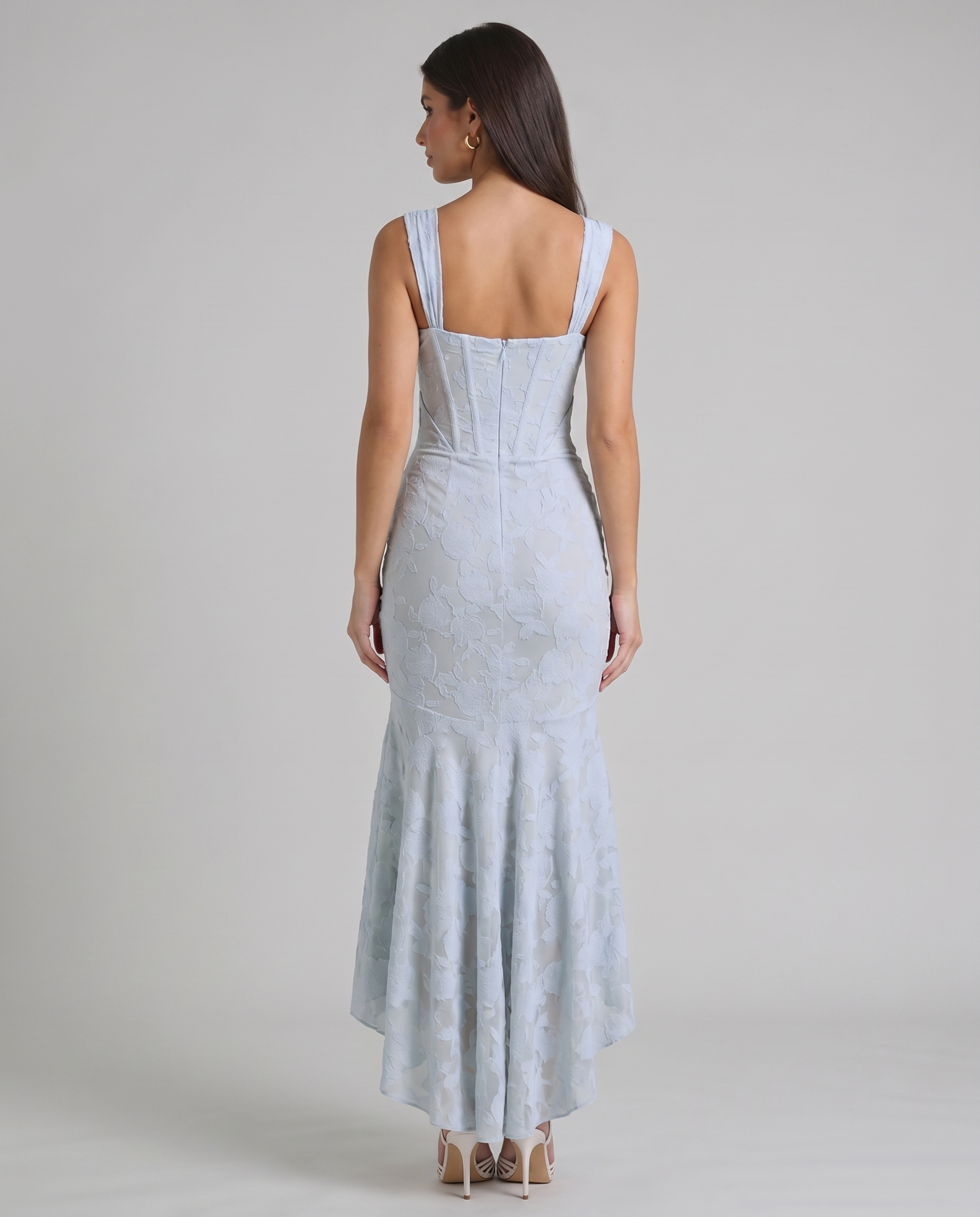 Back view of light blue corset maxi dress showing wide straps, structured seams and back zipper closure