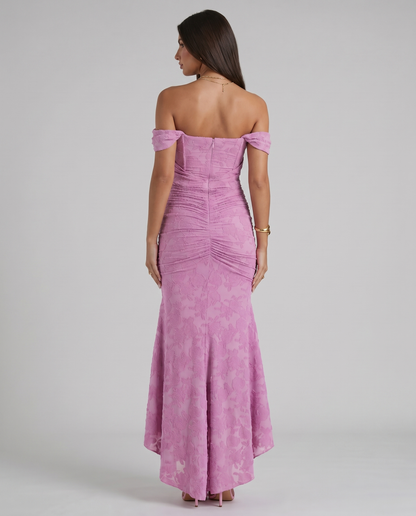 Back view of pink off-shoulder corset maxi dress with center zipper, ruched back and flared skirt