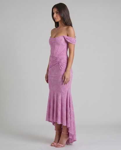 Side view of pink corset maxi dress with structured boning seams, gathered waist detail and high-low skirt