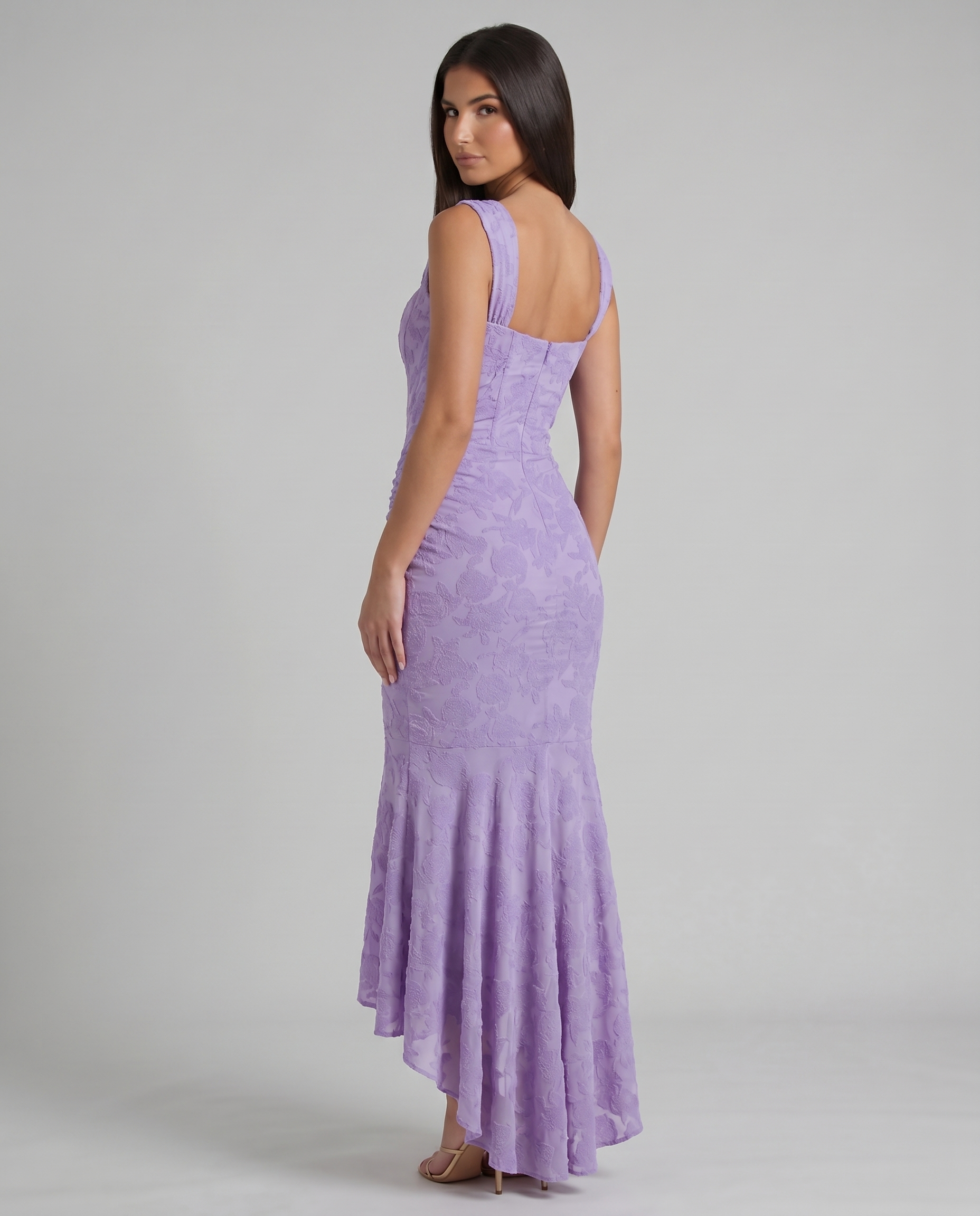 Back view of purple corset maxi dress with straight back neckline, fitted skirt and flared hem
