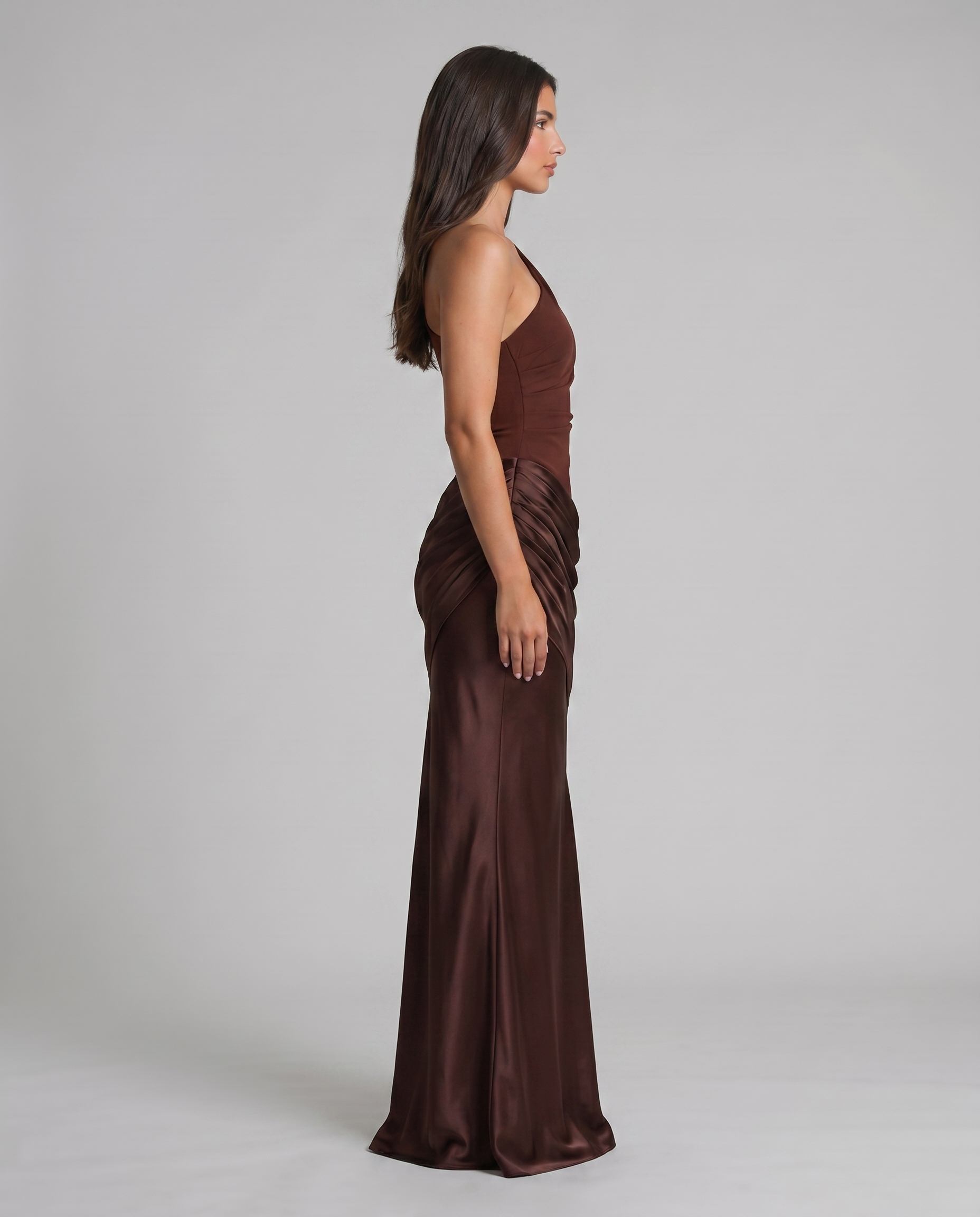 Side profile of brown satin maxi dress, one-shoulder neckline and gathered hip detailing