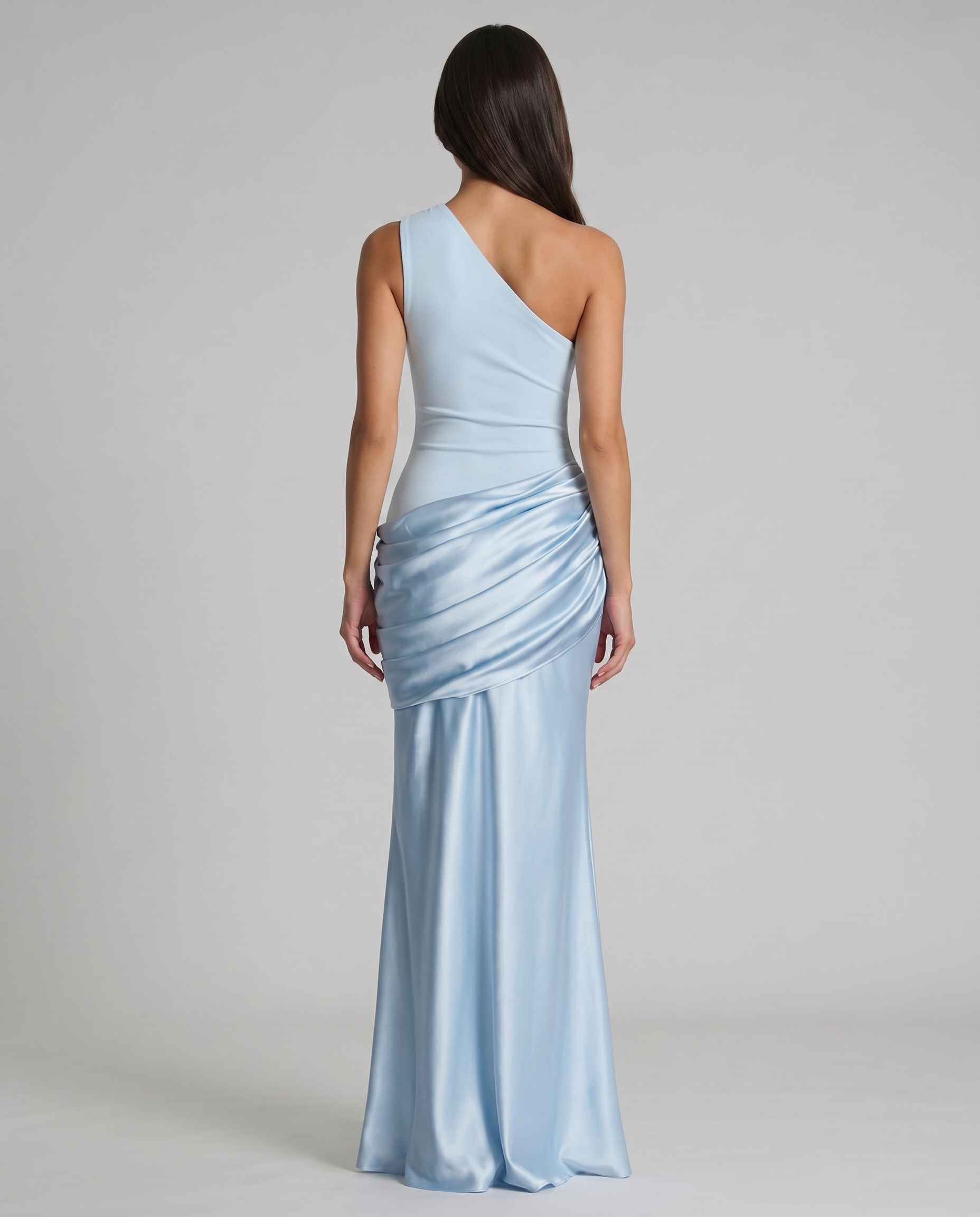 Back view glacier blue one-shoulder maxi dress with asymmetrical neckline and draped satin panel at hips