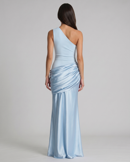 Back view glacier blue one-shoulder maxi dress with asymmetrical neckline and draped satin panel at hips