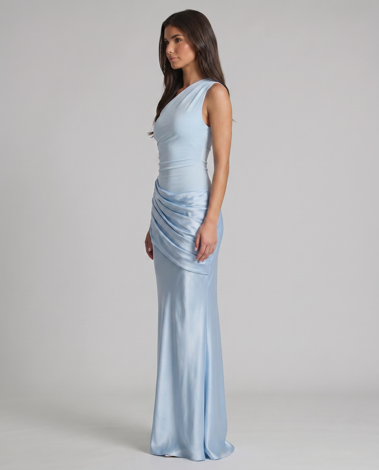 Profile view of glacier blue maxi dress with one-shoulder strap, smooth silhouette, and gathered satin overlay