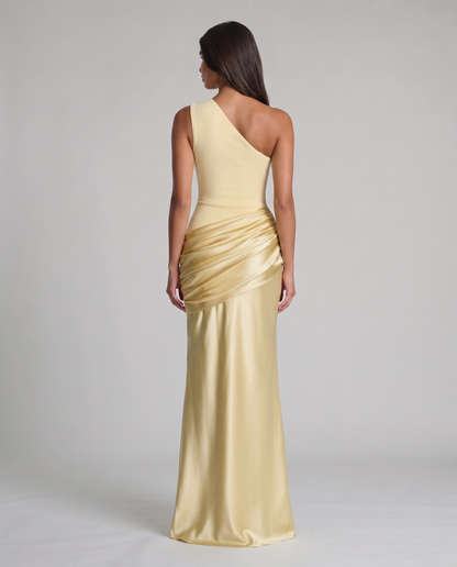 Back view of yellow one-shoulder maxi dress showing asymmetrical neckline and draped ruched skirt